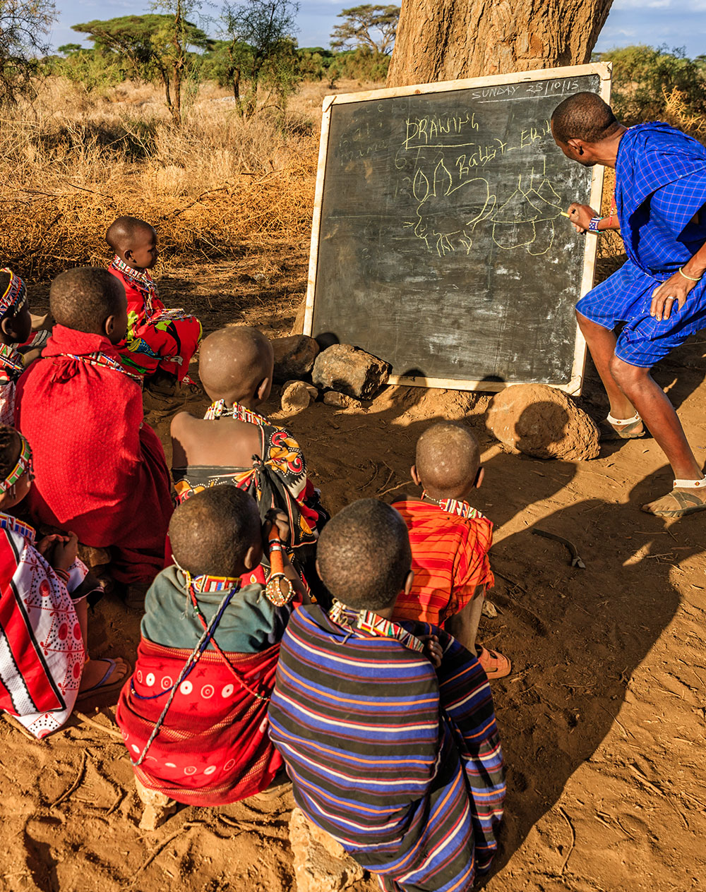 Teacher in the Kenyan countryside teaching pastoralists' children