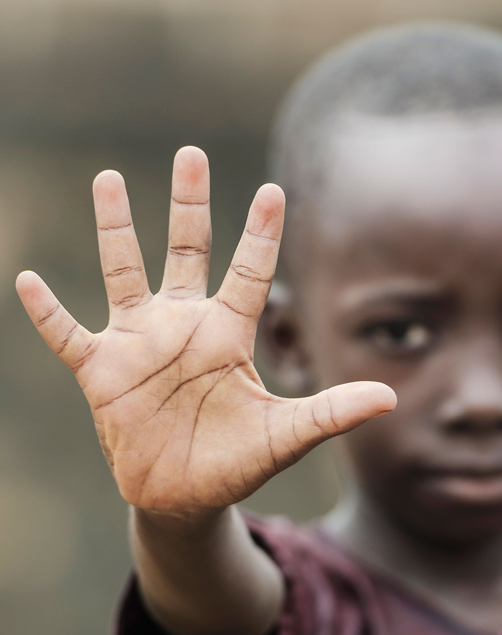 Kenyan street child thrusting out its hand